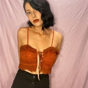 Orange lace corset-style crop top. Super cute layered for Fall!